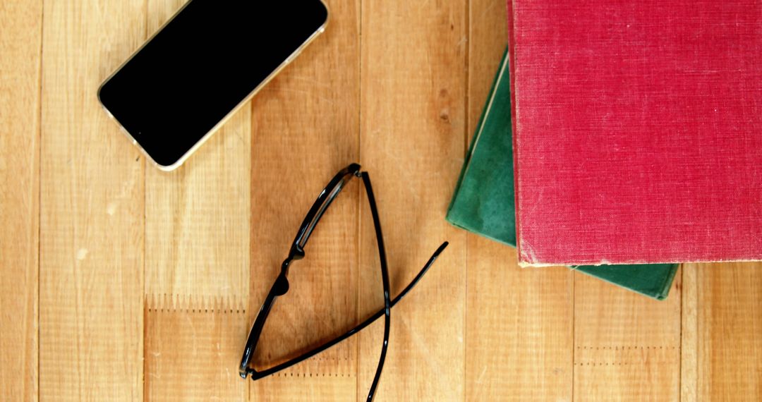 Glasses, Smartphone and Books on Wooden Table - Free Images, Stock Photos and Pictures on Pikwizard.com