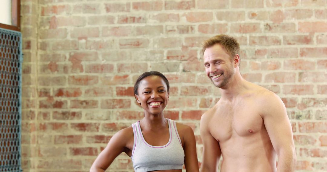 Mixed Race Fitness Friends Smiling in Gym Against Brick Wall - Free Images, Stock Photos and Pictures on Pikwizard.com