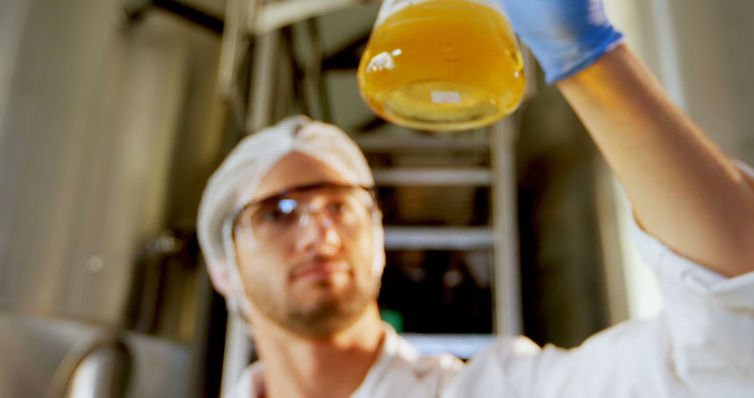 Scientist Examining Liquid in Laboratory Flask - Free Images, Stock Photos and Pictures on Pikwizard.com