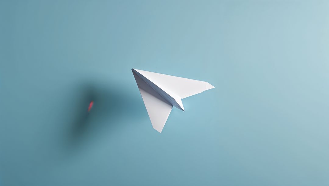 Paper Airplane Soaring in Minimalist Light Blue Space
