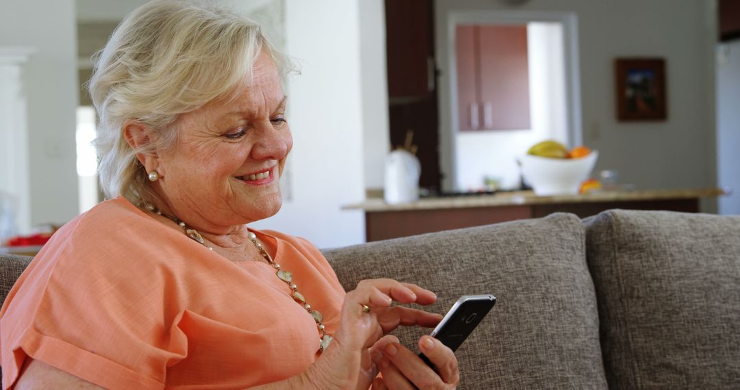 Senior Woman Relaxing on Sofa Using Smartphone at Home - Free Images, Stock Photos and Pictures on Pikwizard.com