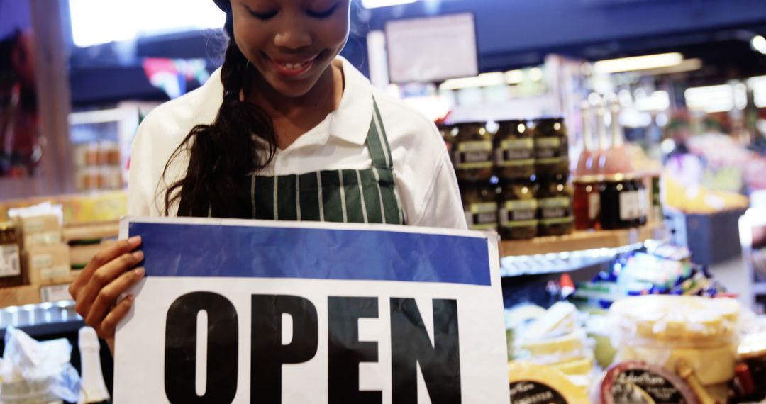 Young Female Shop Owner Holding Open Sign at Store Entrance - Free Images, Stock Photos and Pictures on Pikwizard.com