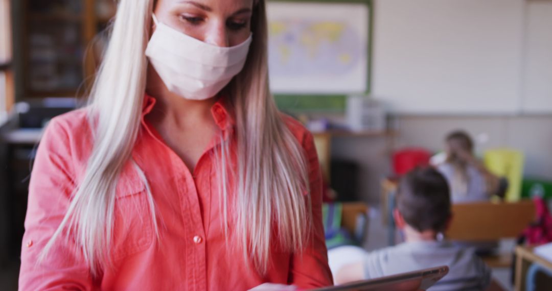 Teacher Using Tablet in Classroom During Pandemic - Free Images, Stock Photos and Pictures on Pikwizard.com