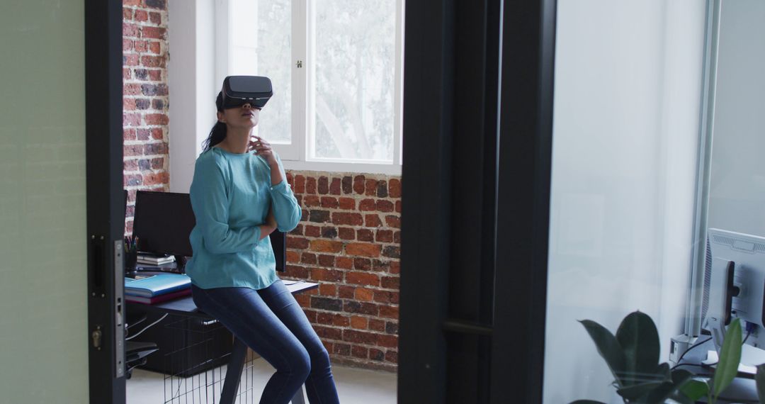 Woman Exploring Virtual Reality in Modern Office Setting - Free Images, Stock Photos and Pictures on Pikwizard.com