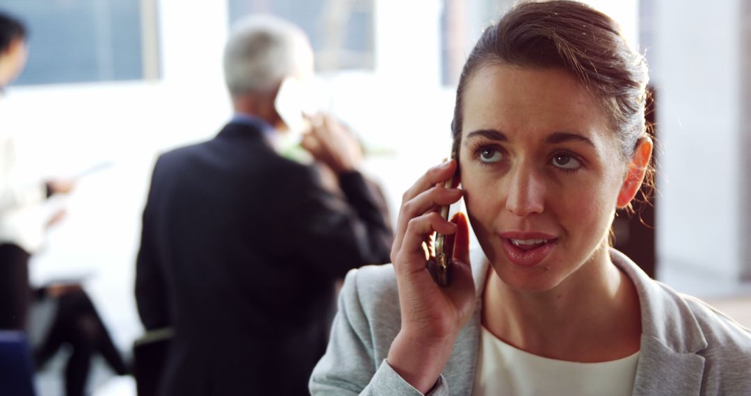 Businesswoman Talking on Phone in Office Environment - Free Images, Stock Photos and Pictures on Pikwizard.com