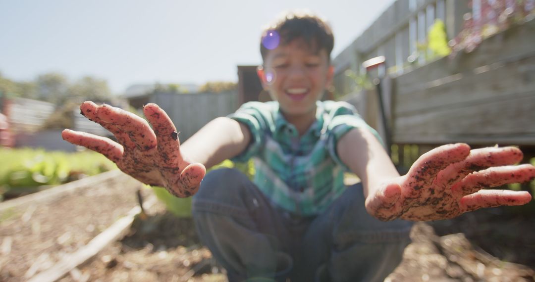 Happy Boy Showing Muddy Hands While Gardening in Backyard - Free Images, Stock Photos and Pictures on Pikwizard.com