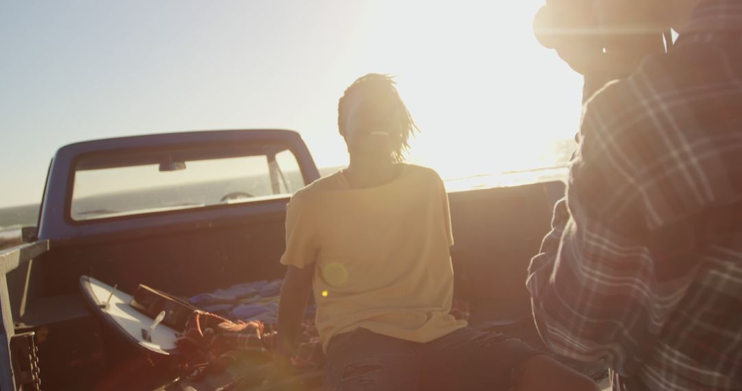 Friends enjoying sunset on a beach in a pick-up truck - Free Images, Stock Photos and Pictures on Pikwizard.com