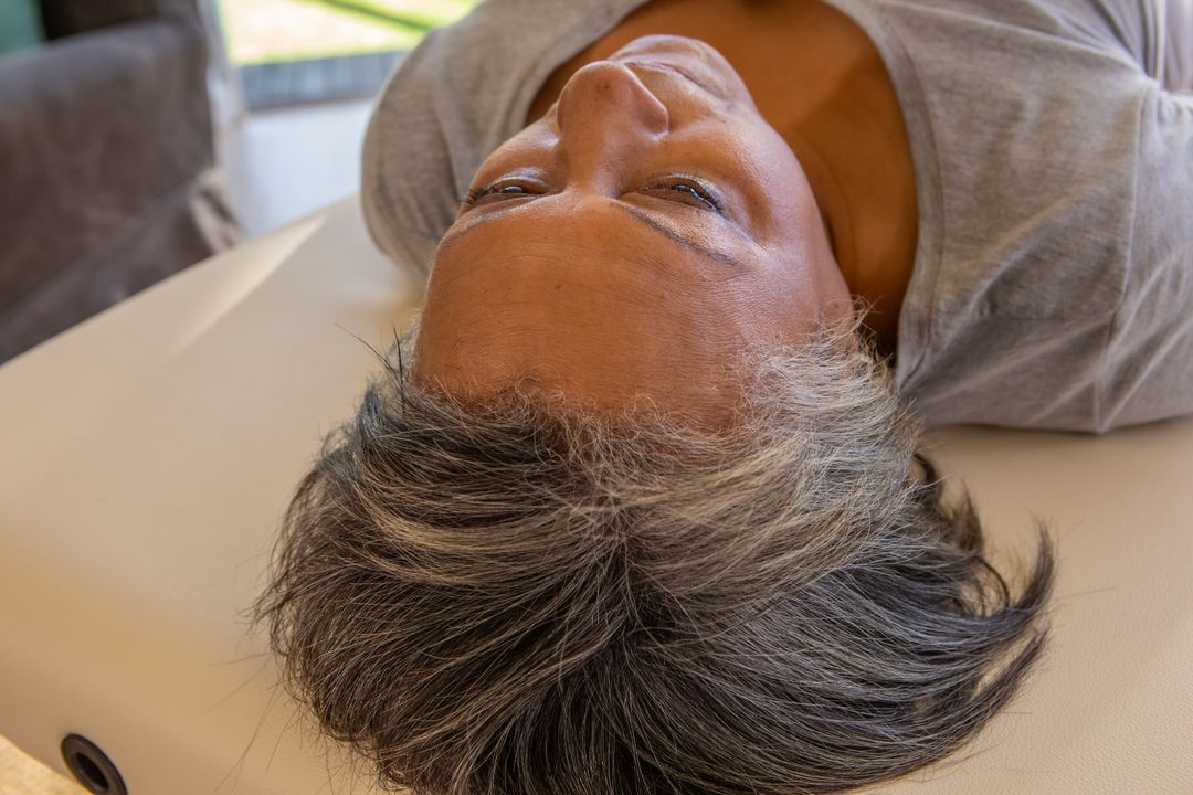 Senior Woman Relaxing on Therapy Table in Natural Eclipse Light