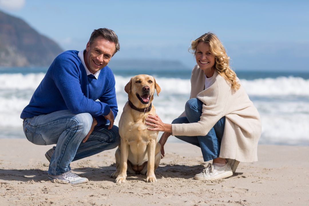 Mature Couple Enjoying Beach with Labrador Retriever - Free Images, Stock Photos and Pictures on Pikwizard.com