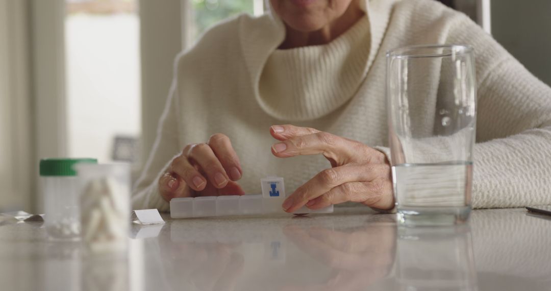 Senior Woman Organizing Medication into Pillbox - Free Images, Stock Photos and Pictures on Pikwizard.com