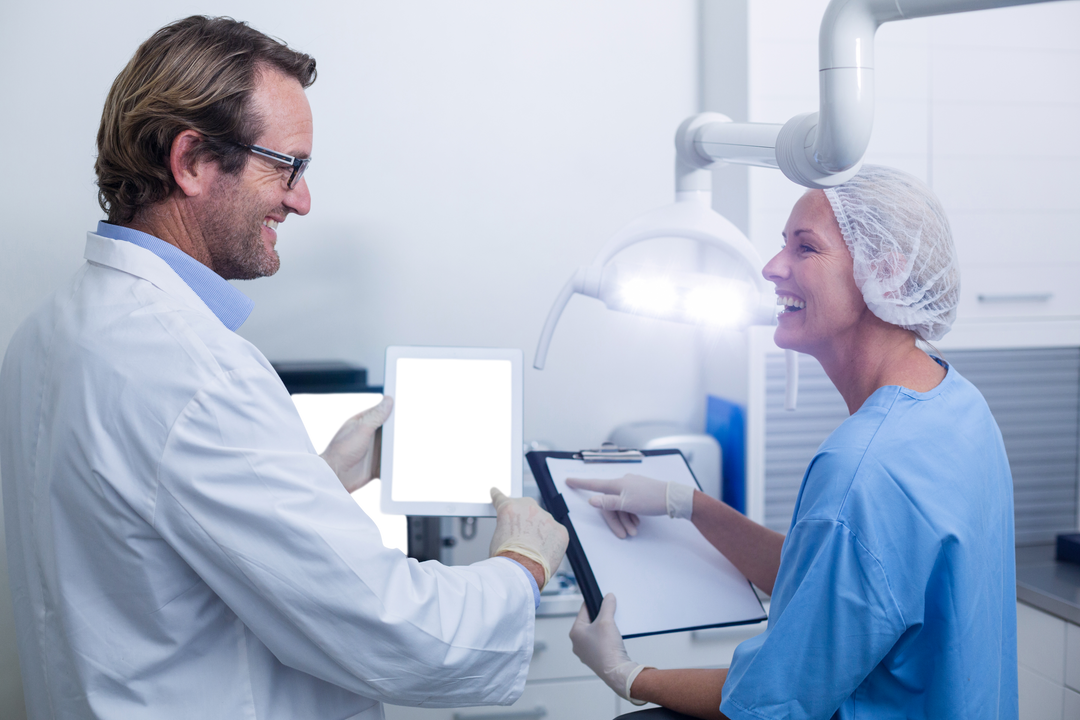 Dentist and Assistant Utilizing Transparent Digital Tablet in Dental Clinic - Download Free Stock Images Pikwizard.com