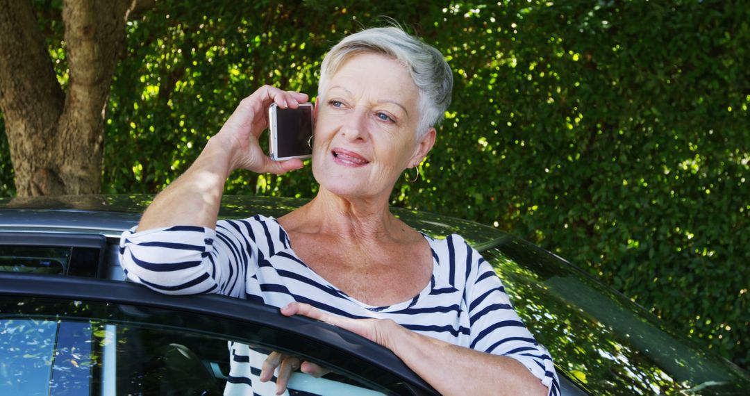 Senior Woman Communicating Via Smartphone Outside a Vehicle - Free Images, Stock Photos and Pictures on Pikwizard.com