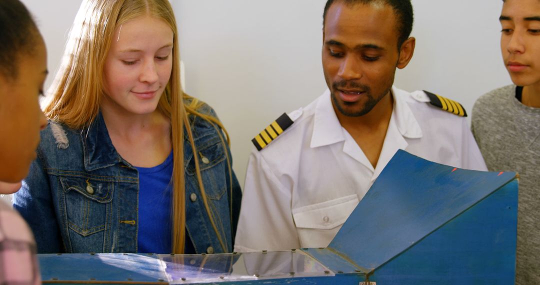 Pilot Explaining Aerodynamic Model to Engaged Students - Free Images, Stock Photos and Pictures on Pikwizard.com