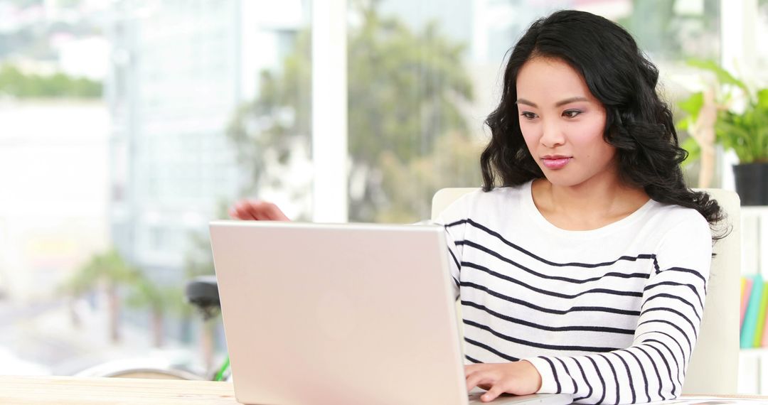 Focused Young Woman Working from Modern Office