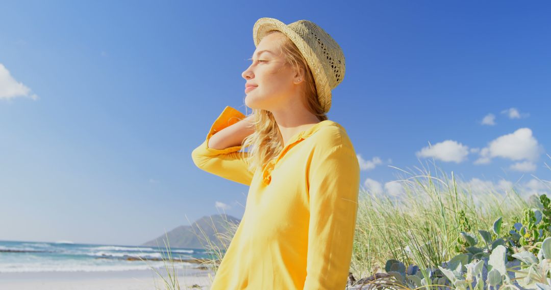 Young Woman Relaxing on Sunlit Beach - Free Images, Stock Photos and Pictures on Pikwizard.com