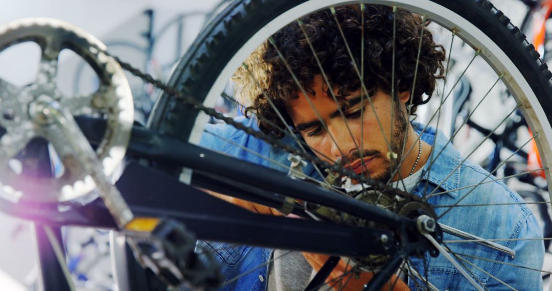 Young Man Repairing Bicycle in Workshop - Free Images, Stock Photos and Pictures on Pikwizard.com