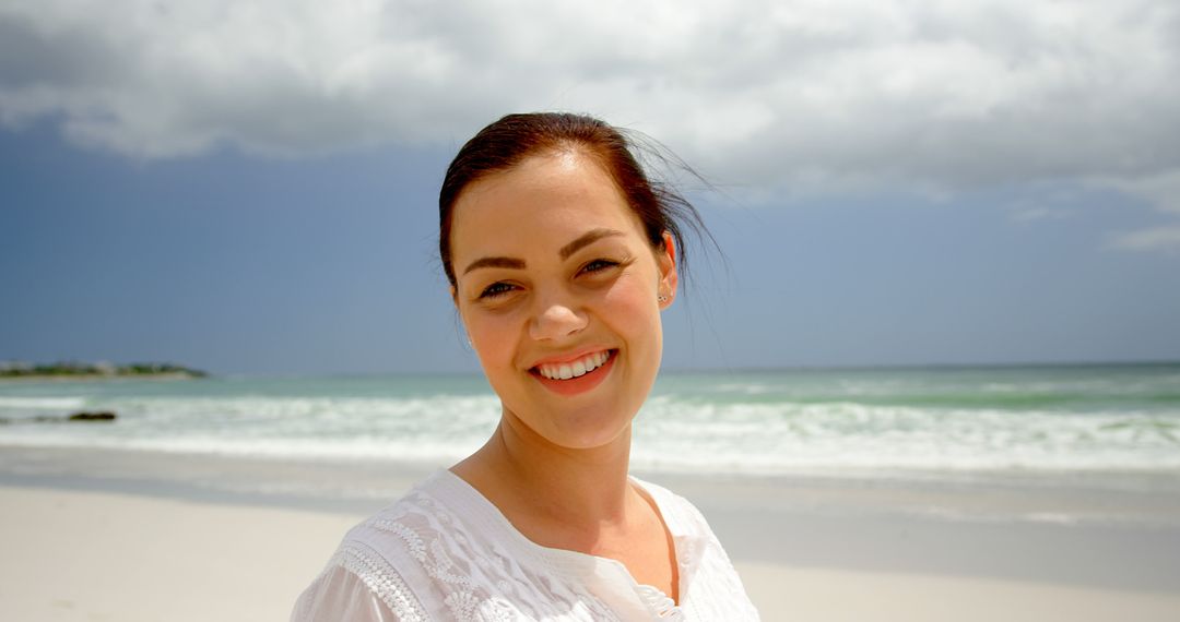 Happy Woman Smiling on Sunny Beach Day - Free Images, Stock Photos and Pictures on Pikwizard.com