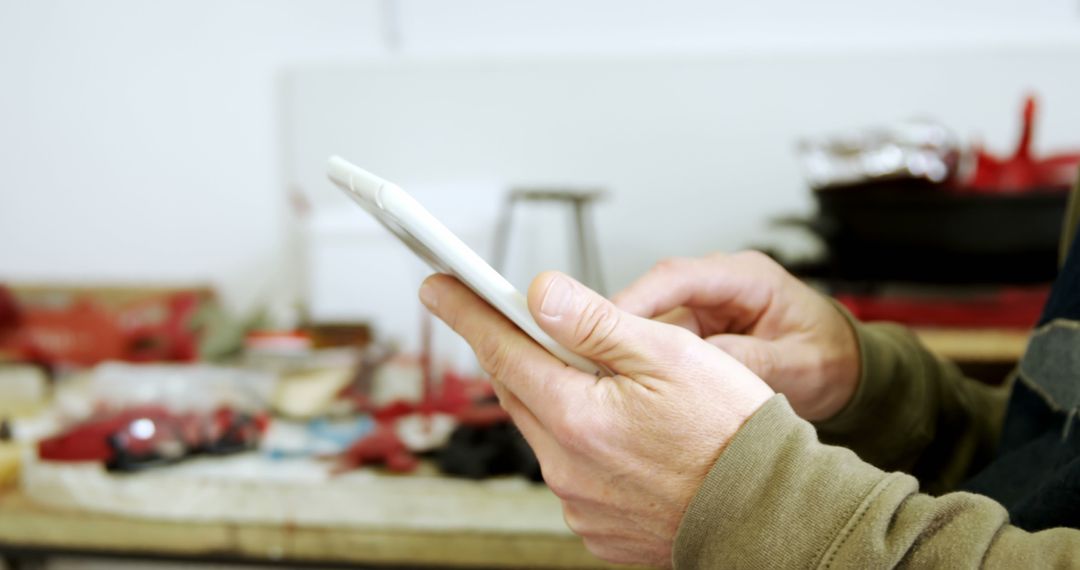 Man Using Tablet in Workshop, Selective Focus on Hands - Free Images, Stock Photos and Pictures on Pikwizard.com