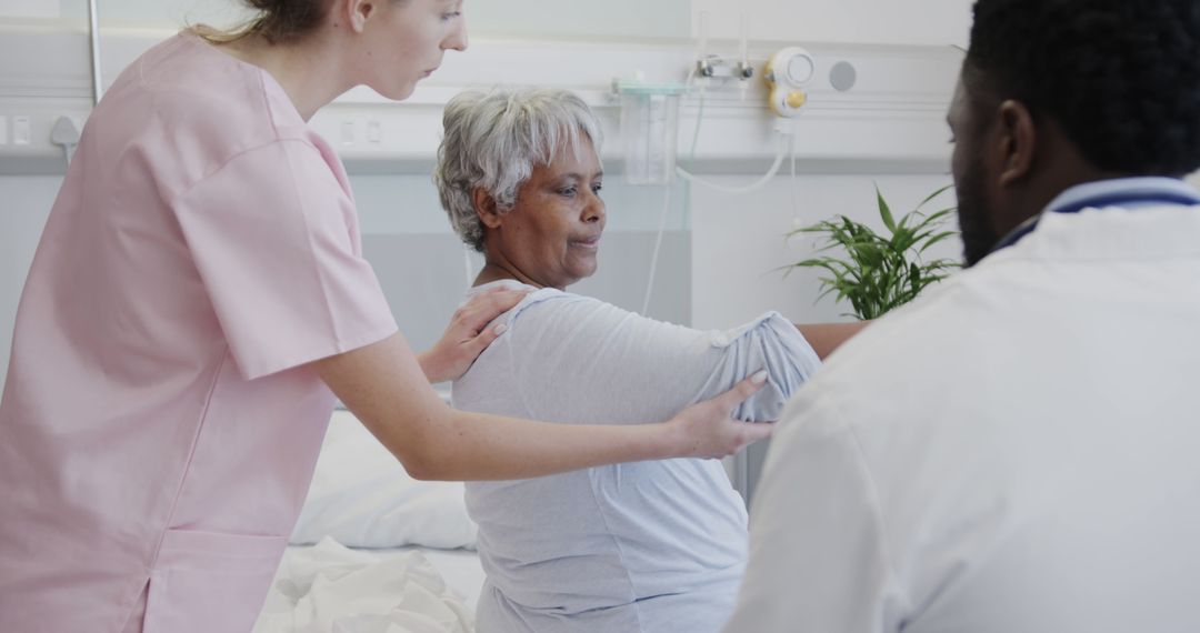 Nurse and doctor assisting elderly patient in hospital bed - Free Images, Stock Photos and Pictures on Pikwizard.com