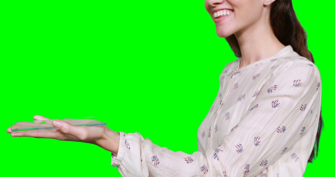 Smiling Woman in Elegant Blouse Holding Invisible Object on Green Screen - Free Images, Stock Photos and Pictures on Pikwizard.com