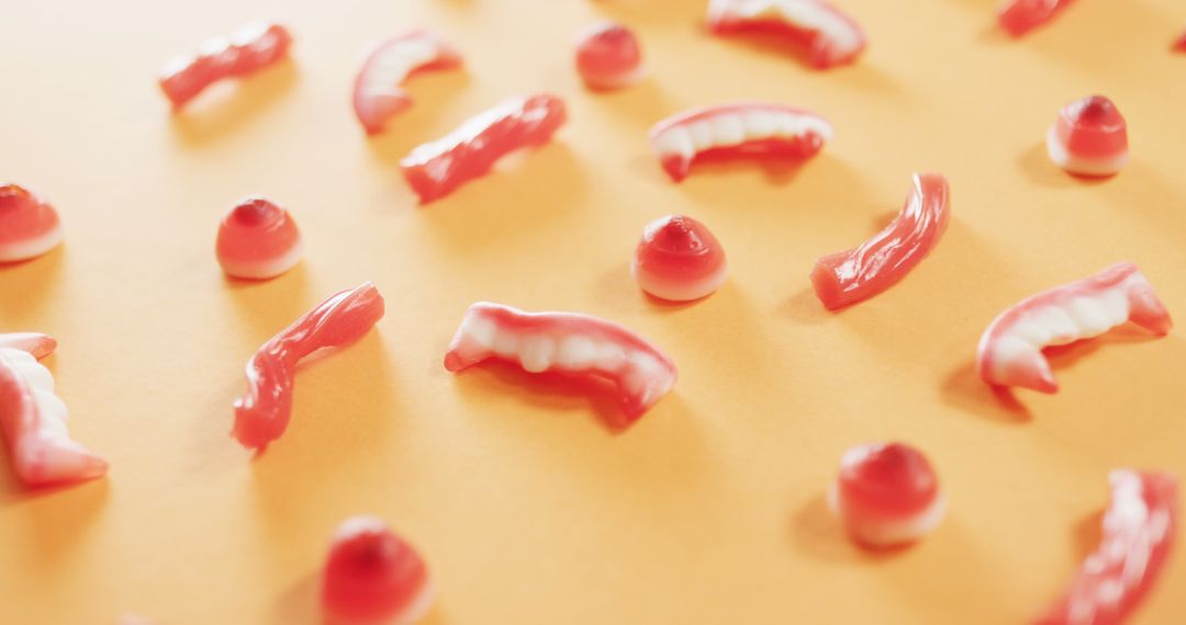 Assortment of Colorful Gelatin Teeth and Gum Shapes on Orange Background - Free Images, Stock Photos and Pictures on Pikwizard.com