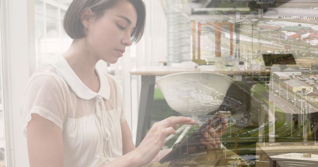 Businesswoman Using Tablet Overlaid on Urban Cityscape