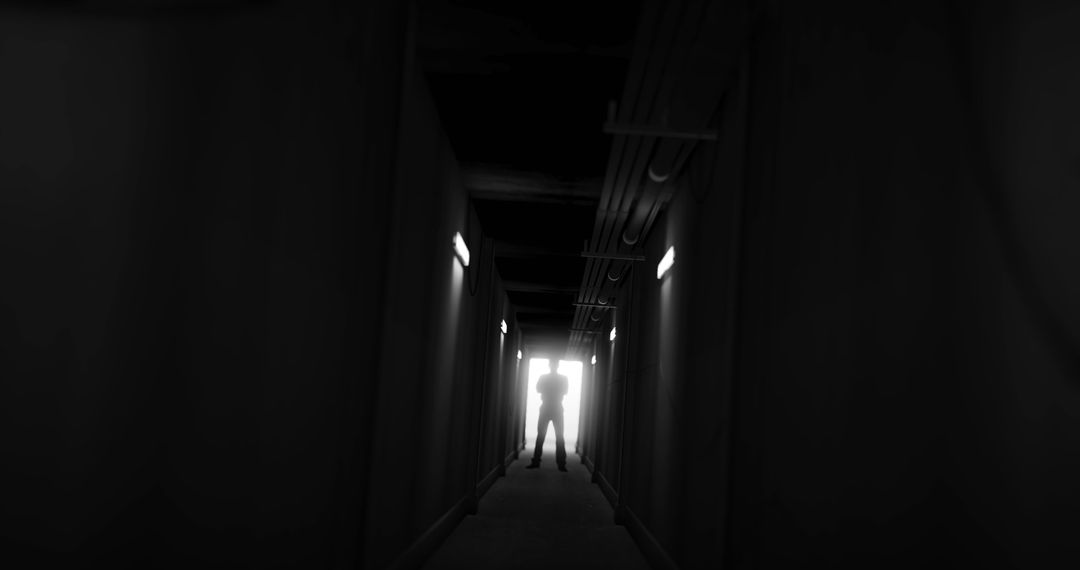 Silhouette of a Man in a Dimly Lit Area Corridor