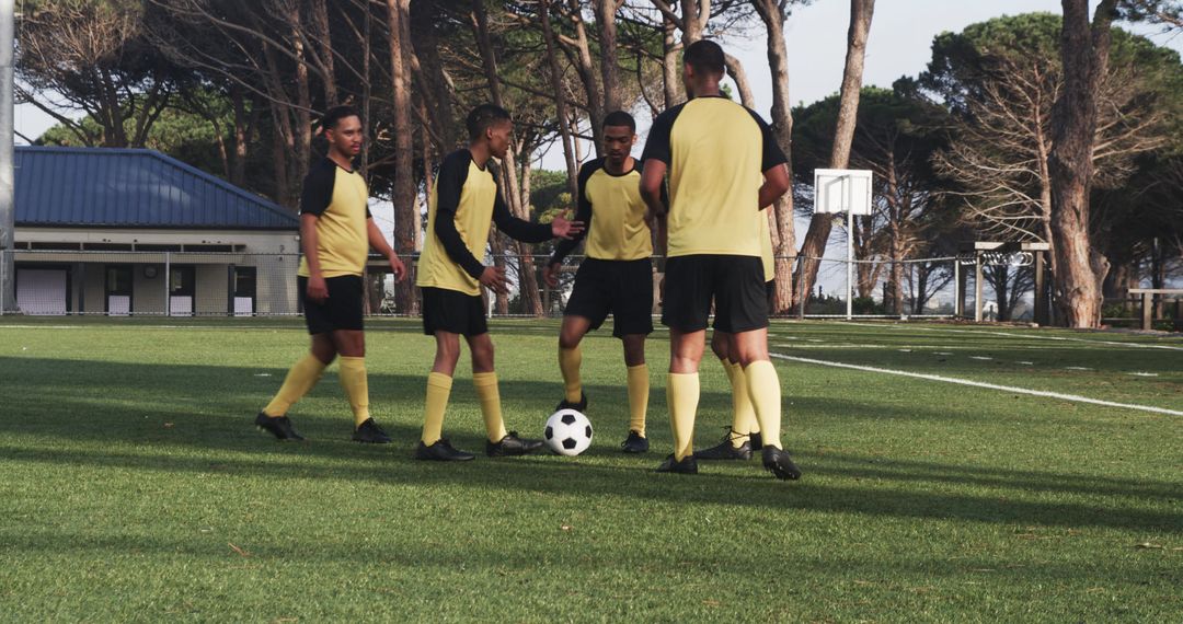 Soccer Team Strategizing On Field: Players in Action