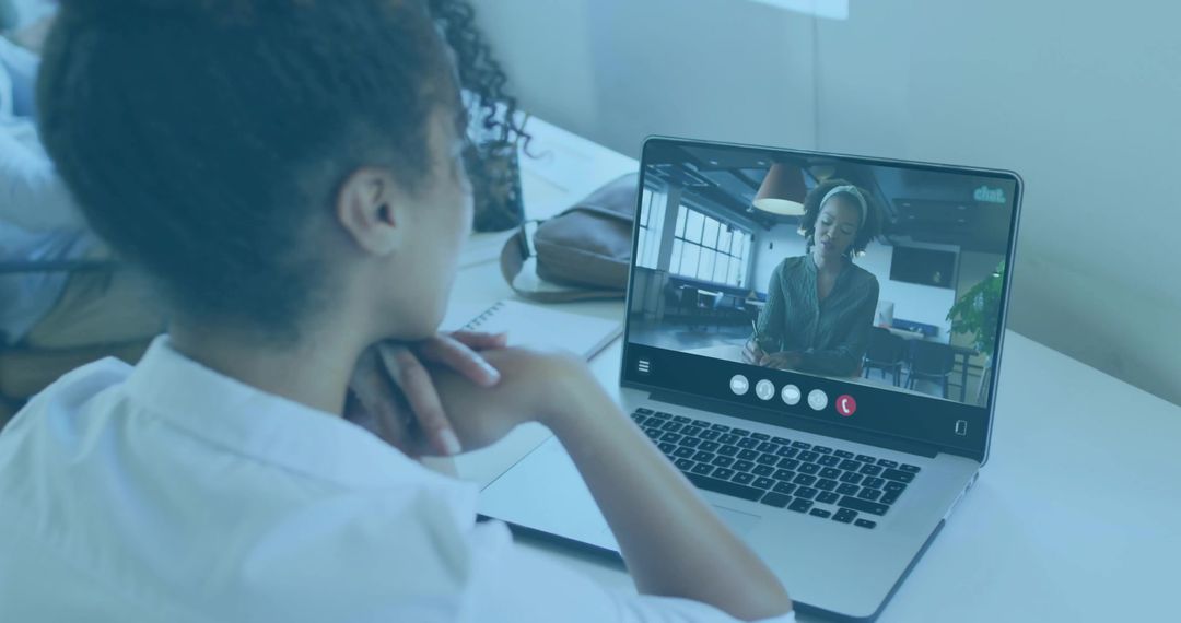 Woman in Video Call at Home Workspace with Laptop and Notes