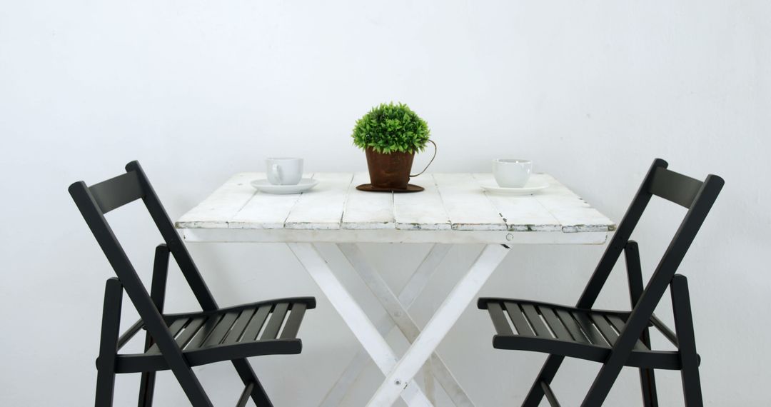 Minimalist White Table with Chairs and Plant Decor - Free Images, Stock Photos and Pictures on Pikwizard.com