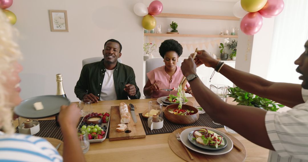 Friends Sharing a Festive Meal and Conversation at Home