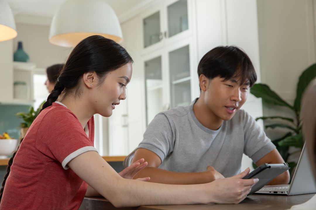 Diverse Family Collaborating with Modern Technology in Home Kitchen