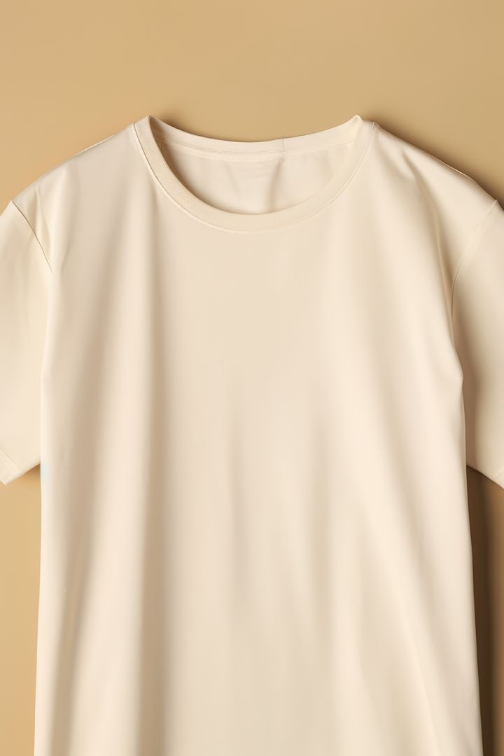 Cream Color Blank T-Shirt Isolated Against Beige Background - Free Images, Stock Photos and Pictures on Pikwizard.com