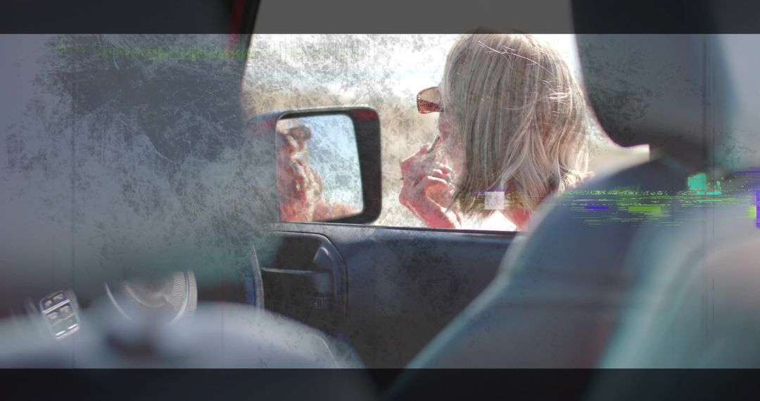 Woman Applying Lipstick Using Side Mirror Capturing Elegant Moment