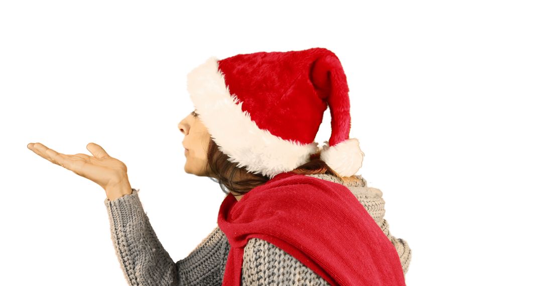 Woman Blowing Kiss while Wearing Santa Hat and Christmas Outfit - Free Images, Stock Photos and Pictures on Pikwizard.com