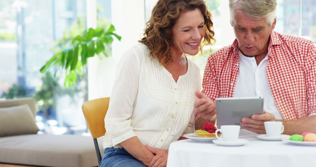 Mature Couple Enjoying Time with Tablet at Home