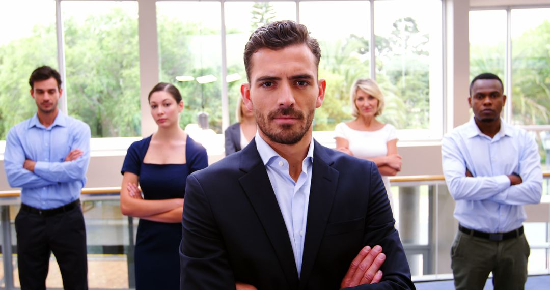 Confident Multiracial Team in Bright Office Setting with Leader in Focus