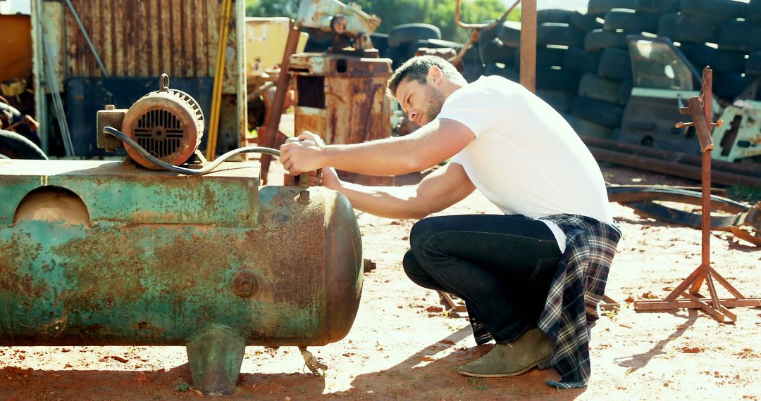 Man Restoring Vintage Machine in Outdoor Workshop - Free Images, Stock Photos and Pictures on Pikwizard.com