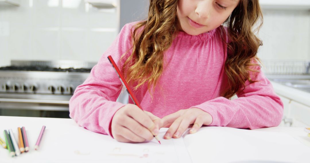 Young Girl Drawing with Colored Pencils in Kitchen - Free Images, Stock Photos and Pictures on Pikwizard.com