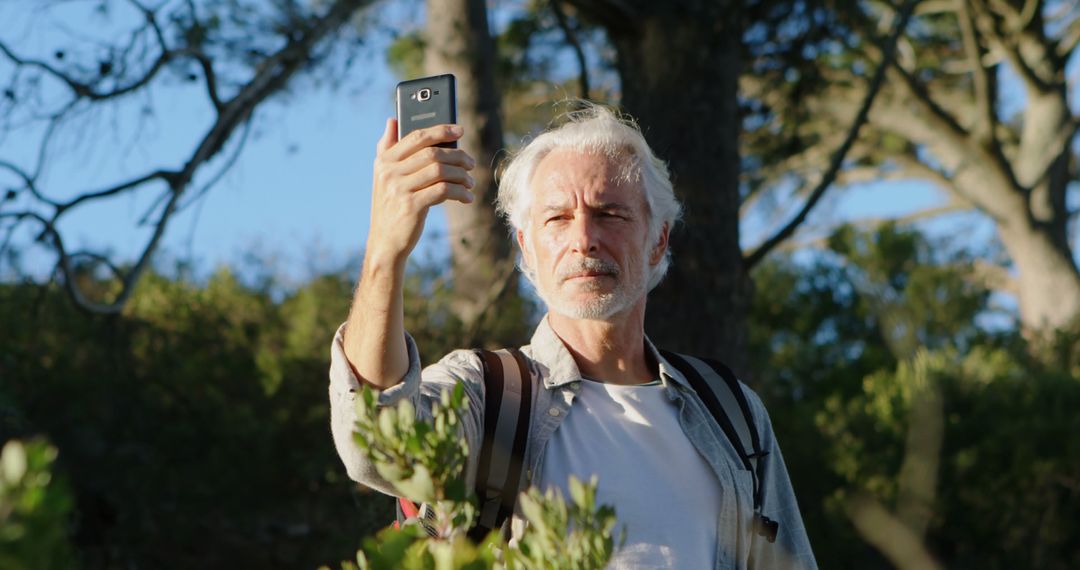 Senior Man Enjoying Outdoor Hike, Taking Photo with Smartphone - Free Images, Stock Photos and Pictures on Pikwizard.com