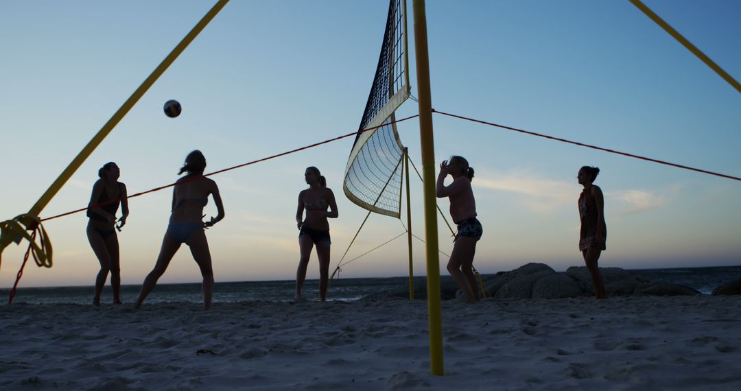 People Playing Beach Volleyball at Sunset - Free Images, Stock Photos and Pictures on Pikwizard.com