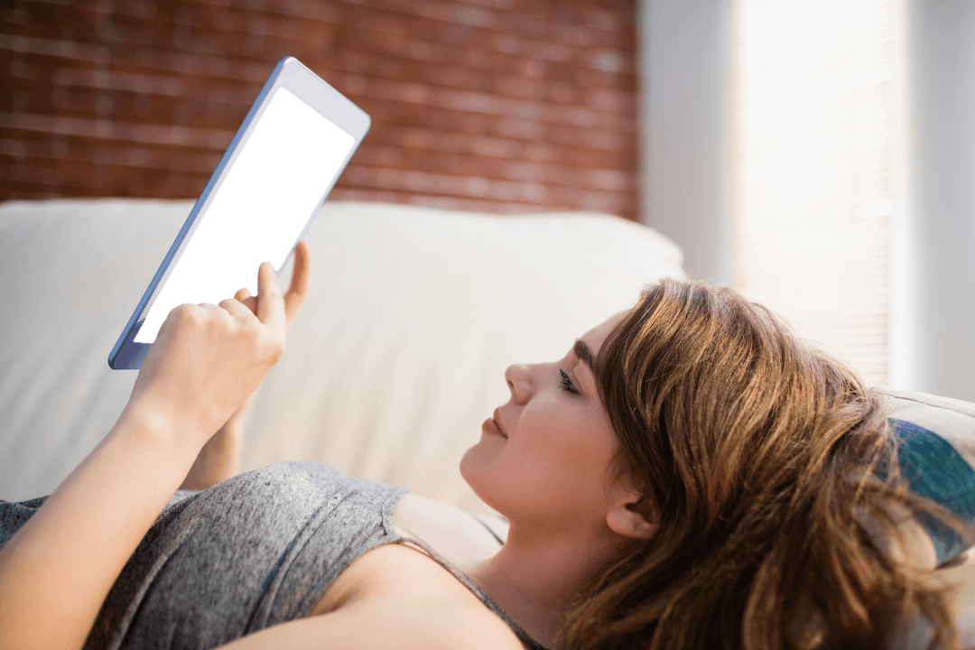 Woman Relaxing on Couch Using Transparent Tablet