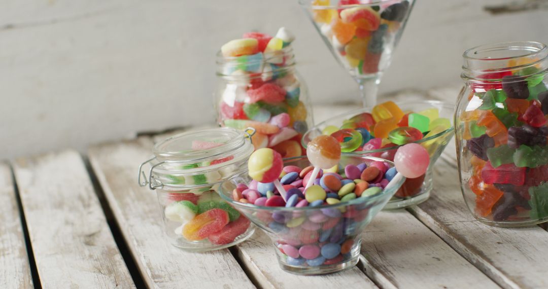 Assorted Colorful Candies in Jars and Glassware on Wooden Table - Free Images, Stock Photos and Pictures on Pikwizard.com