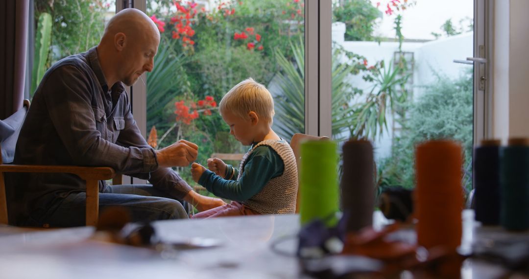 Father and Son Enjoying Creative Time with Crafts and Stitching