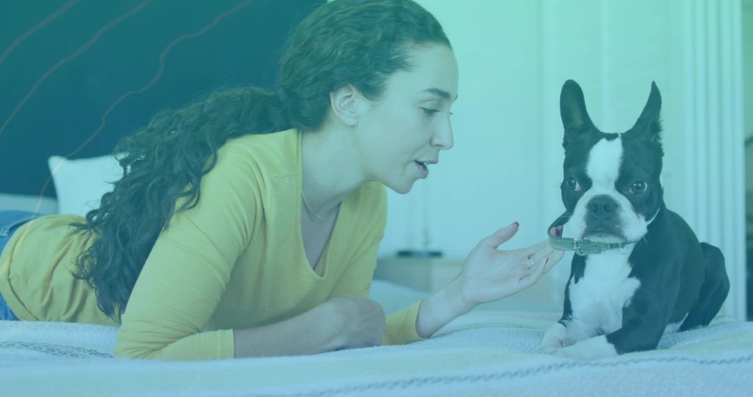 Woman Interacting with Dog on Bed in Relaxed Atmosphere