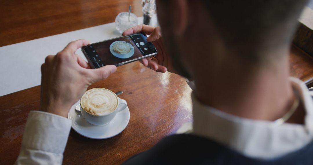 Person Taking Photo of Cappuccino in Cafe - Free Images, Stock Photos and Pictures on Pikwizard.com