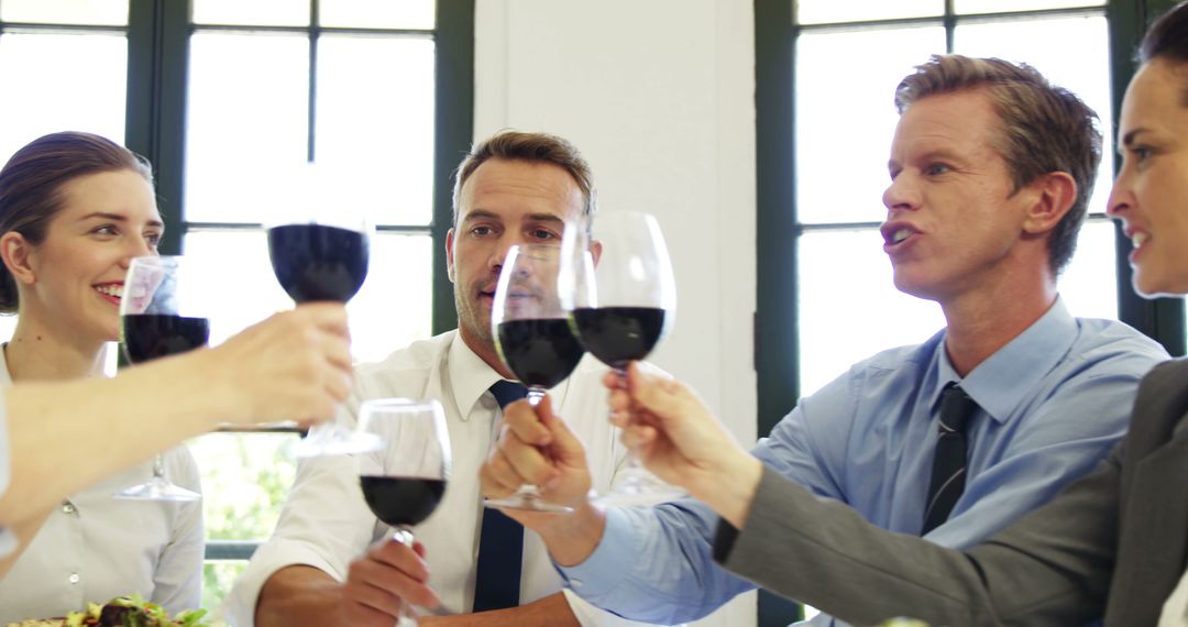 Business Team Celebrating with a Toast during Lunch Meeting