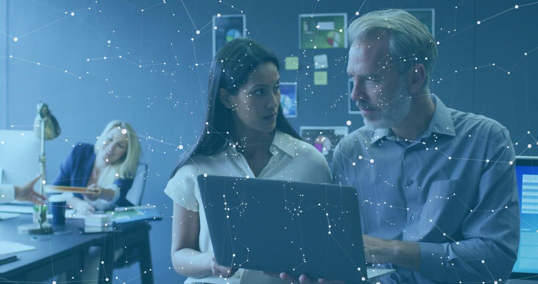 Collaborative Teamwork in Modern Office with Futuristic Technology Display