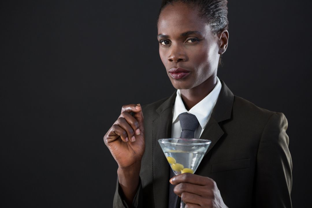 Androgynous man holding a martini glass - Free Images, Stock Photos and Pictures on Pikwizard.com
