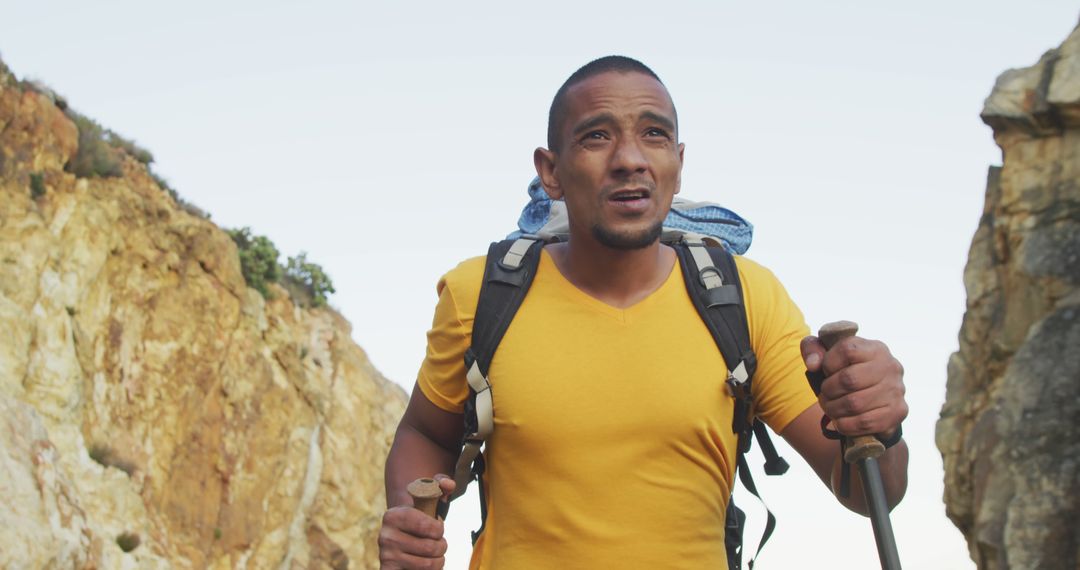 Determined Cyclist Exploring Mountain Trail with Walking Poles